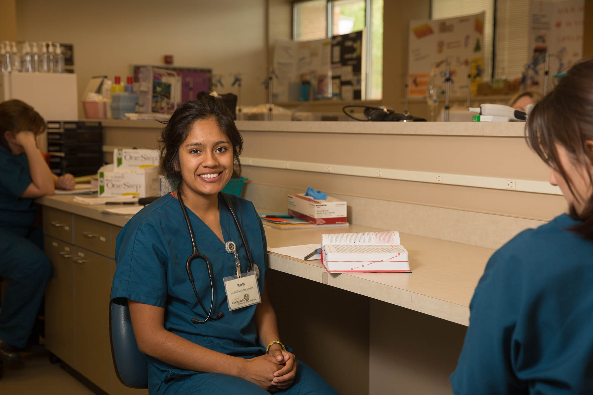 Medical assisting student sitting down